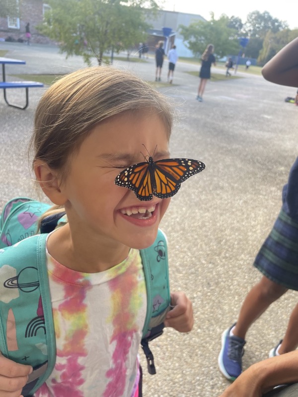 Girl with monarch on nose