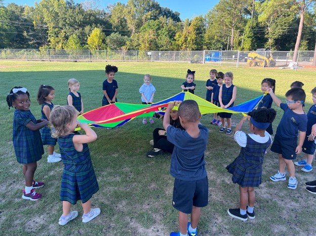PreK students playing the parachute game