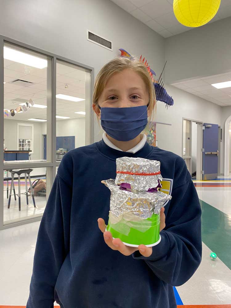 student holding cup robot